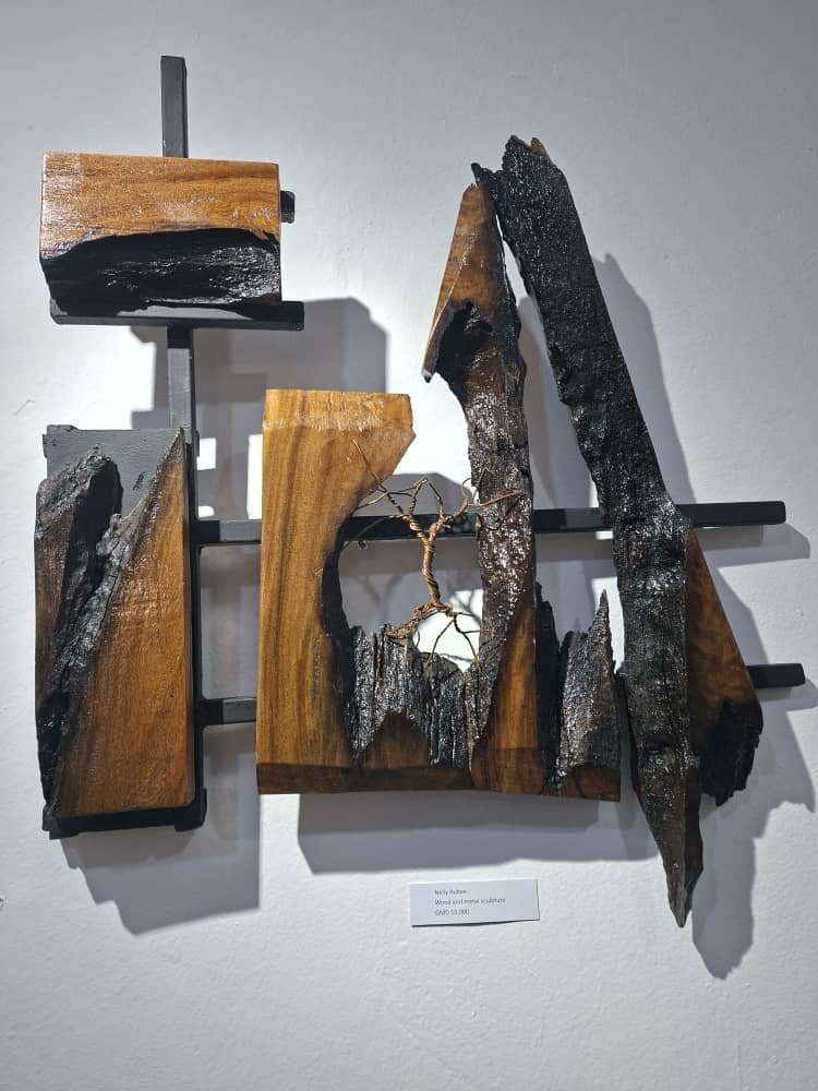 A sculptural wall piece made of charred and natural wood